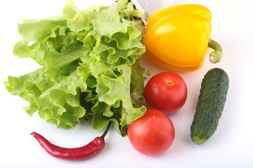 Assorted vegetables, fresh bell pepper, tomato, chilli pepper, cucumber and lettuce isolated on white background. Selective focus.