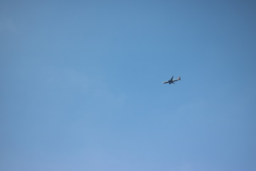 Cloudless clear blue sky. Background. And a plane is flying. Go on holiday and arrive safely and on time. 