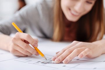 Admirable engaged woman drawing the line with preciseness