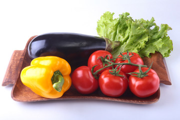 Fresh assorted vegetables, eggplant, bell pepper, tomato, garlic with leaf lettuce. Isolated on white background. Selective focus.