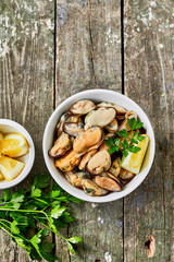 Mussels with lemon and herbs. Shellfish seafood. Delicious snack for gourmands.Top view