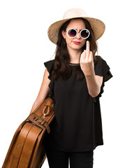 Beautiful young girl with  a suitcase making horn gesture