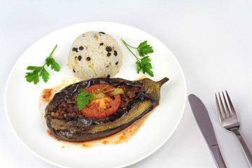 Turkish cuisine. Karniyarik and rice pilaf with black corinth raisin. Eggplant stuffed ground meat.