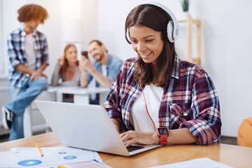 Savvy young woman employing modern technologies for studying