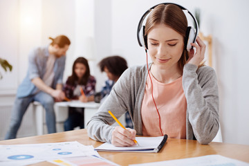 Attentive productive young student making a transcript