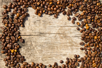 Coffee beans frame on grunge wooden background