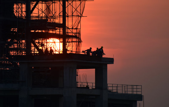 construction site and sunset , structural steel beam build large residential buildings at construction site . 