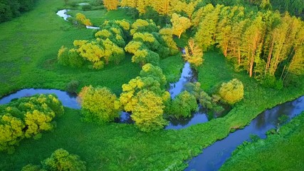 Aerial flight over river valley in beautiful sunset light