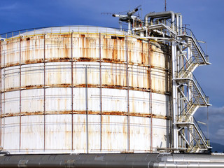 Refinery crude oil storage tanks at large, with the old rust and corrosion from the session.