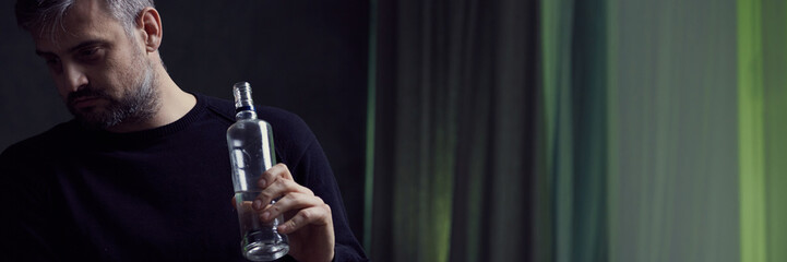 Man holding bottle of alcohol