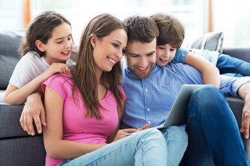 Family using laptop at home
