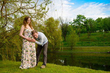 Happy pregnant woman and her husband in the park