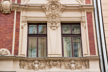 Two vintage designer window on the facade of the old house