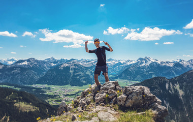 Crazy happy hiker on mountain summit