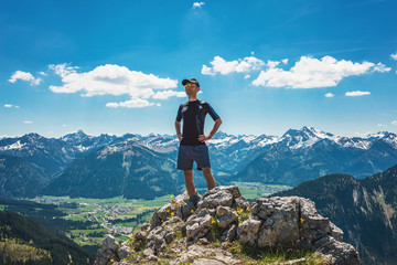 Obraz premium Confident hiker on mountain summit