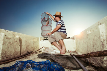 Fisherman getting the catch from the net