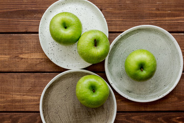 summer food with green apples on wooden background top view