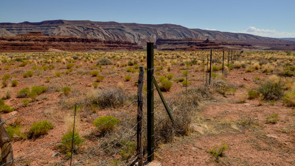 Fototapeta na wymiar cattle fencing in the desert between Arizona and Utah U.S. Route 163 National Scenic Byway, Mexican Hat, San Juan County, Utah, United States