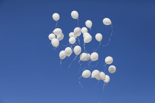 White balloons in the sky. 