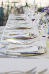 Wedding table. Plates and cutlery set out for a wedding