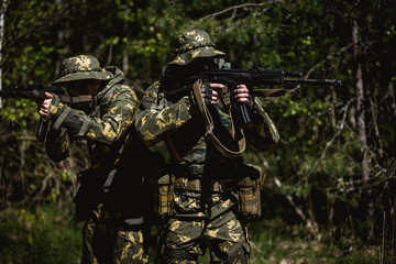 Fototapeta premium Military men with submachine gun