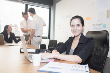 Businessmoman work ing with businessman while using computer  , 20-30 year old