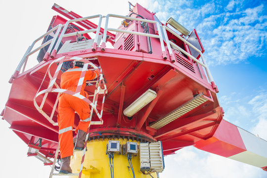 Crane Operator Climb Up To Crane Cabin To Perform Lifting Operation At Oil And Gas Wellhead Remote Platform, Offshore Oil And Gas Occupational.