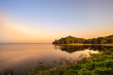 abstract surreal of sunset on dam and forest