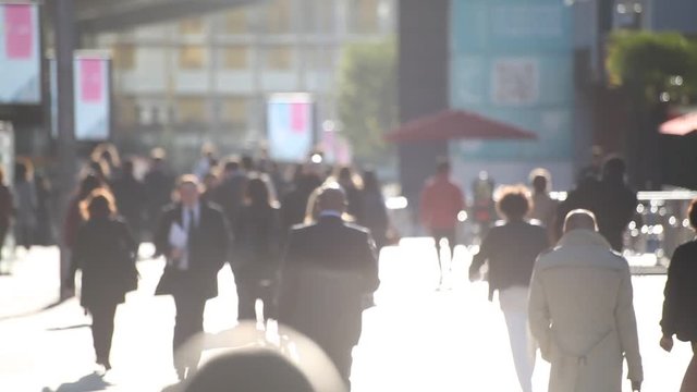 people walking on the street in abstract big city, back light, Europe