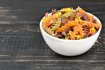 Colorful fusilli pasta in bowl