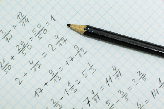 Math problems on graph paper with black pencil