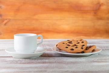 cookie chocolate and tea on a wooden table