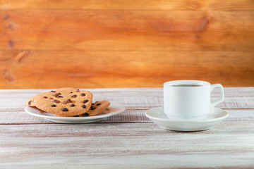 cookie chocolate and tea on a wooden table