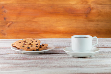 cookie chocolate and tea on a wooden table