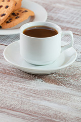 cookie chocolate and tea on a wooden table