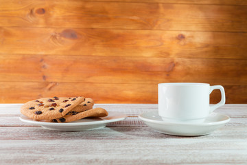 cookie chocolate and tea on a wooden table