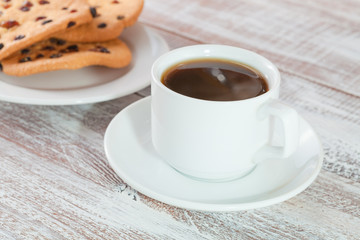 cookie chocolate and tea on a wooden table