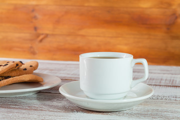 cookie chocolate and tea on a wooden table