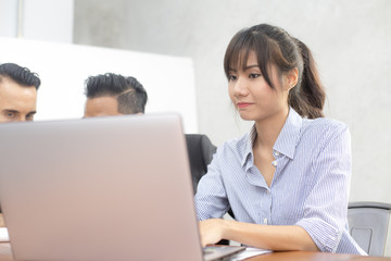 Obraz premium Young woman using laptop for work at modern place, Business people working in modern office. Greeting deal concept