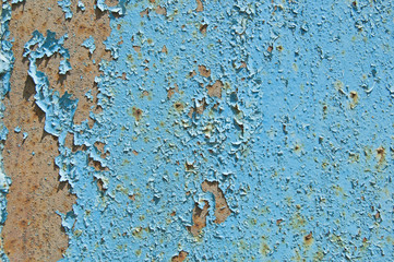 Old cracked paint pattern on rusty background. Peeling blue grunge material. Damaged metal surface. Scratched plate