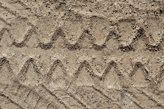 Truck tyre track on sand.
