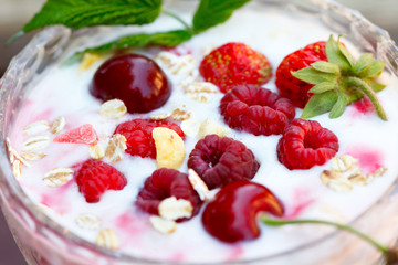 Homemade Pink Raspberry yogurt with fresh berries in glass bowl, closeup, selective focus