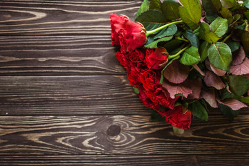 Beautiful red roses on a rustic background
