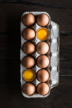 Carton of whole and cracked eggs
