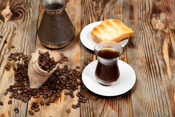 Breakfast, toast and Turkish coffee on a wooden background