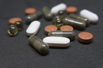 Assorted pills on black