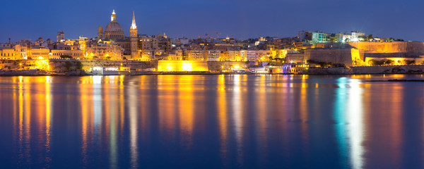 Valletta Skyline at night with church of Our Lady of Mount Carmel and St. Paul's Anglican Pro-Cathedral, Valletta, Capital city of Malta. Panoramic view from Sliema. © Kavalenkava