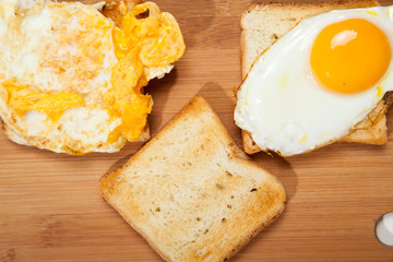Toasts and egg on a white wooden table