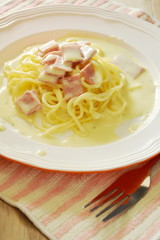 spaghetti carbonara topping slice ham pork on plate