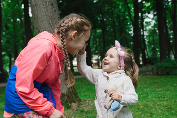 Children walk in the park on a day off. The sun is shining